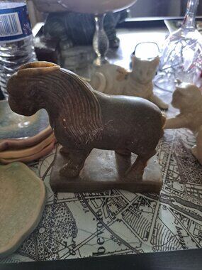 This carving appears to be a stone or soapstone figure of a horse or similar ani